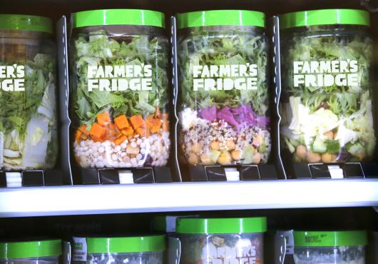 Three jars of salad inside a Farmers Fridge vending machine