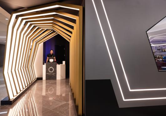 A friendly front desk worker in front of the elaborate portal entrance 