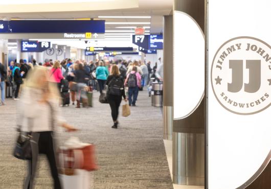 A food court image of Jimmy John's in a bustling airport