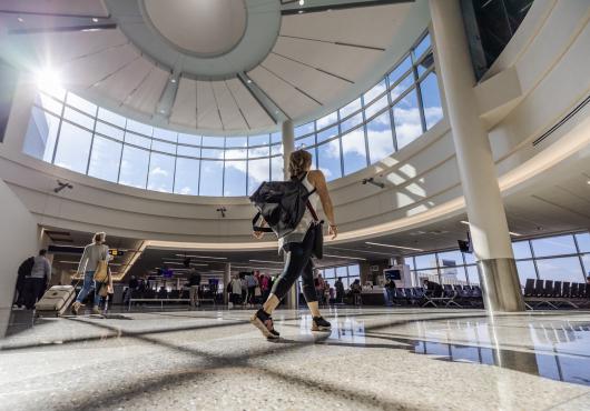 A passenger walks over a new terrazzo floor equipped with Hearing Loop Technology