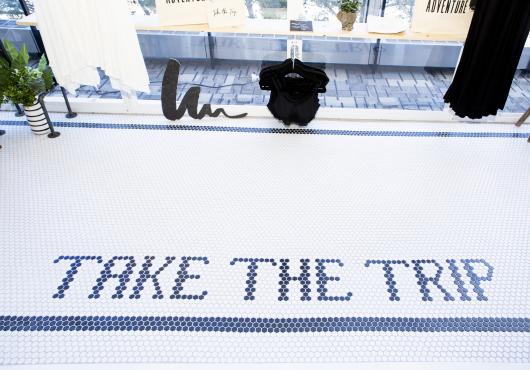 Image of the floor at Urban Undercover reading "Take the Trip" 