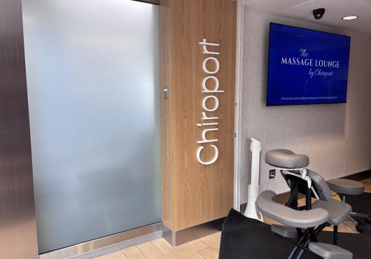 image of the front of the Massage Lounge location with a massage chair 