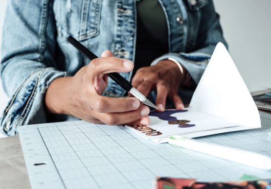 hands and tools making a greeting card 