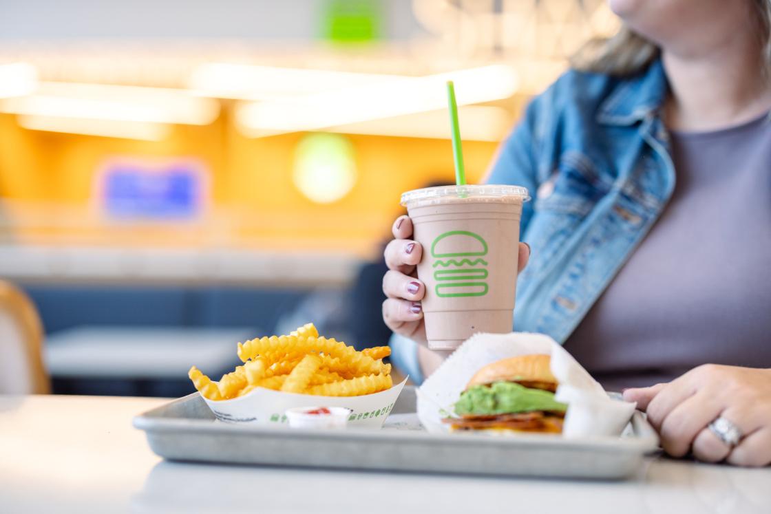 A Shake Shack meal consisting of a burger, fries and shake.