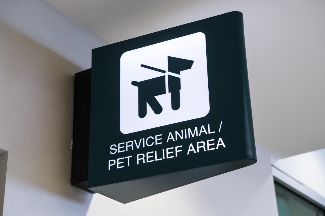 Photo of the signage used to mark Service Animal Relief Areas featuring an icon of a dog with a leash