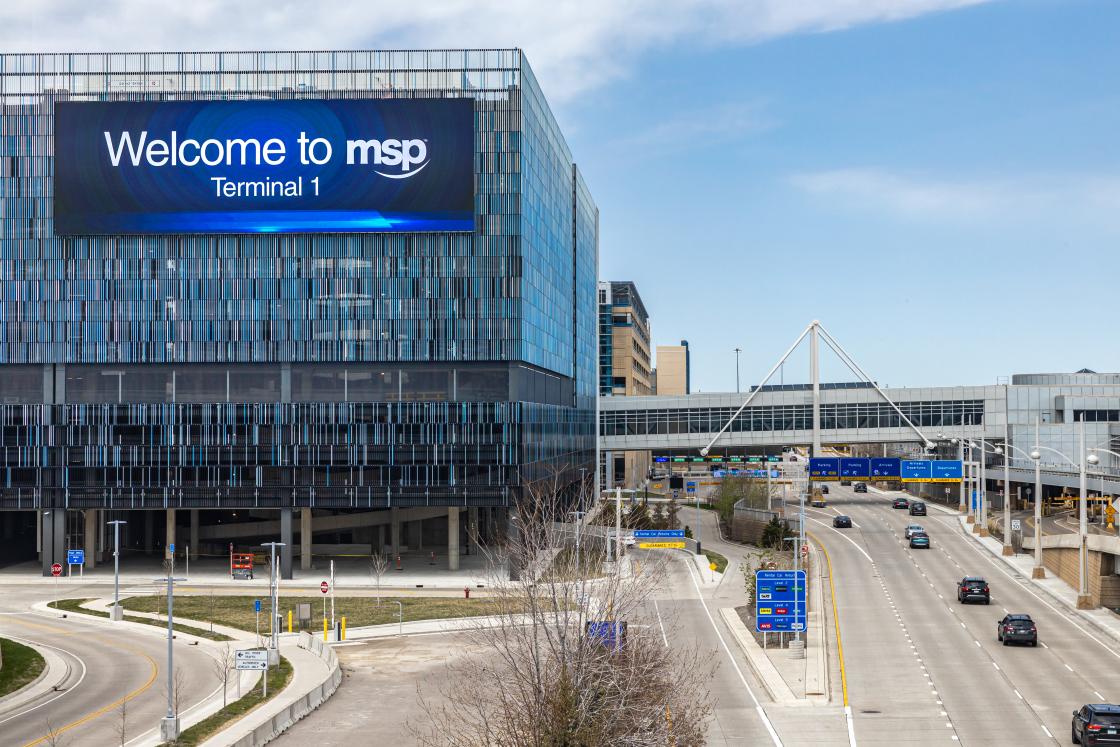 A view of Terminal 1 on the inbound roadway with a billboard reading "Welcome to Terminal 1." 