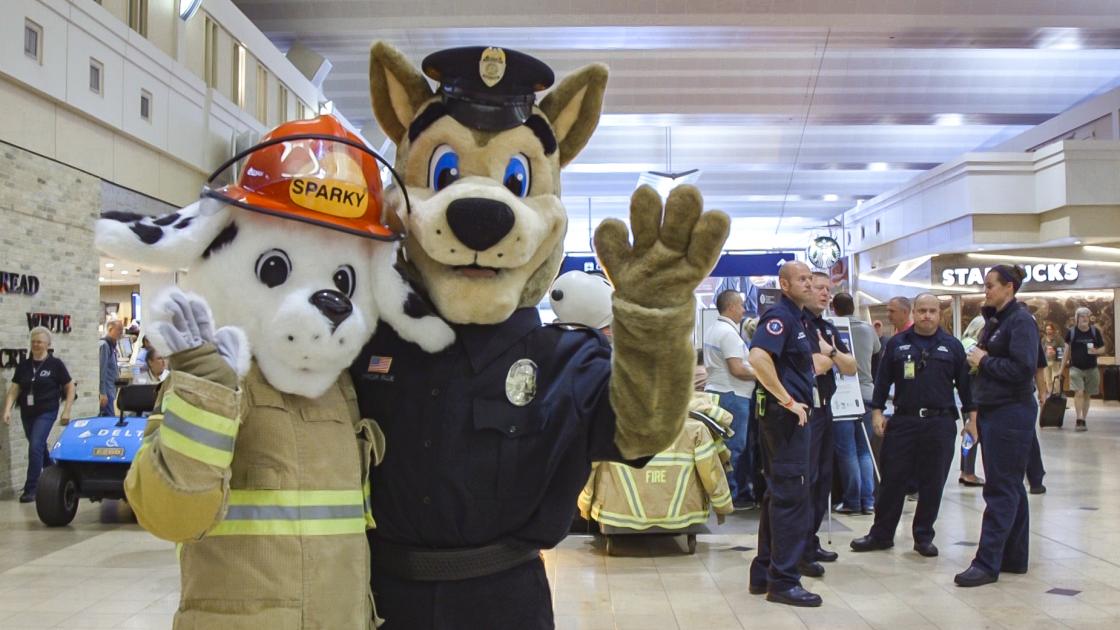 image of canine mascots from the airport fire and police departments Sparky and Blue