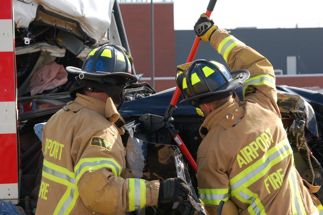 Two firefighters practicing vehicle extrication