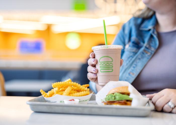 A Shake Shack meal consisting of a burger, fries and shake.