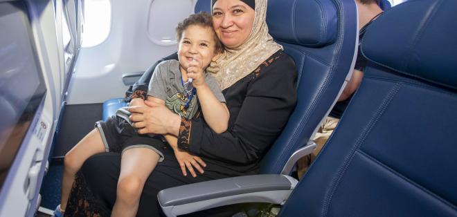A family participating in the Navigating MSP program on a plane. 